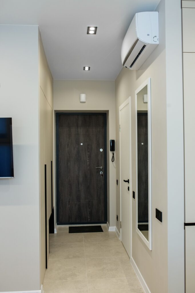 Corridor in the apartment. Tile floor heating. Air conditioner